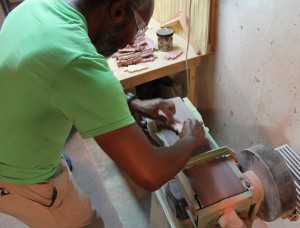 Robert sands each tree after they are cut.